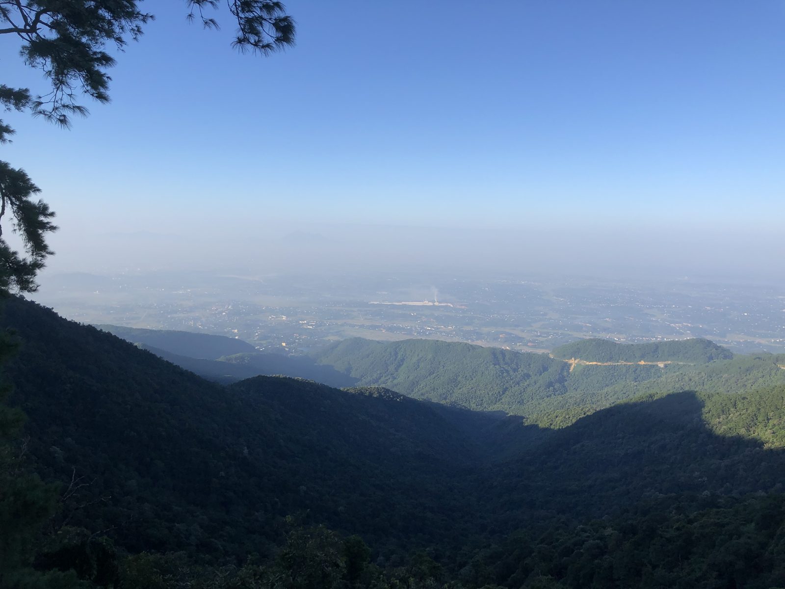 View from Tam Đảo over forested slopes and the hazy plain